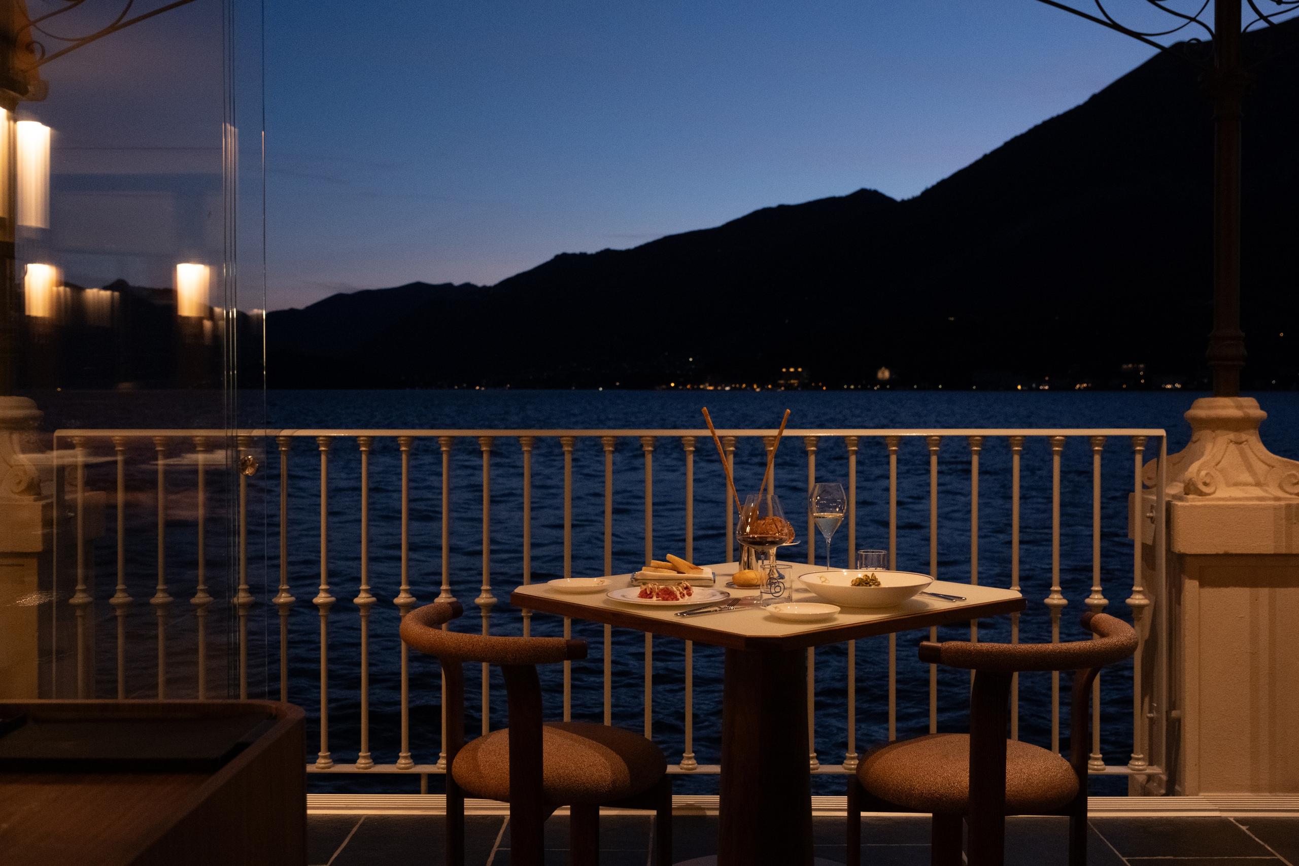 Table at dusk on the restaurant terrace overlooking Lake Como